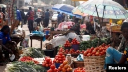 FILE - Vendors and shoppers are seen the Mvog Ada market in Yaounde, Cameroon, Jan. 29, 2022.