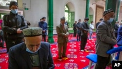 FILE - Uyghurs pray at the Id Kah Mosque in Kashgar in far west China's Xinjiang region, as seen during a government-organized visit for foreign journalists, April 19, 2021.