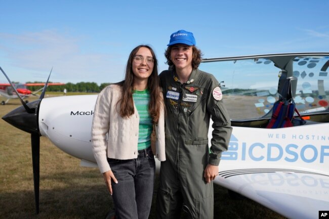 Seventeen year old Anglo-Belgian pilot, Mack Rutherford, right, poses with his sister Zara Rutherford after landing at the Buzet airfield in Pont-A-Celles, Belgium, Tuesday, Aug. 23, 2022. (AP Photo/Virginia Mayo)