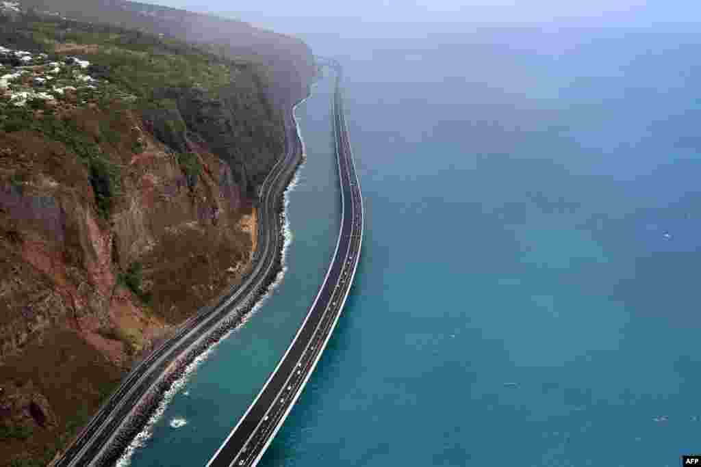 This aerial view shows vehicles travelling on the &#39;New Coastal Road&#39; &#39;Nouvelle Route du Littoral (NRL)&#39; near Saint-Denis La Reunion on the French Indian Ocean Island of Reunion, after it was partially opened.