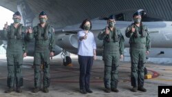 In this photo released by the Taiwan Ministry of National Defense, Taiwan's President Tsai Ing-wen is briefed during a visit to a naval station on Penghu, an archipelago of several dozen islands off Taiwan's western coast, Aug. 30, 2022.