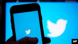 FILE: FILE - The Twitter application is seen on a digital device. A former head of security at Twitter has filed whistleblower complaints with U.S. officials alleging that the company misled regulators.
