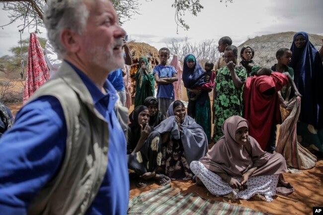 World Food Program chief David Beasley, left, meets with villagers in the village of Wagalla in northern Kenya Friday, Aug. 19, 2022. (AP Photo/Brian Inganga)