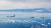 FILE - In this photo from Xinhua News Agency, aircraft of the Eastern Theater Command of the Chinese People's Liberation Army train near Taiwan Island, Aug. 7, 2022. A Pentagon report says China has increased "unsafe" military behavior toward the U.S. and its allies.