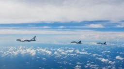 FILE - In this photo from Xinhua News Agency, aircraft of the Eastern Theater Command of the Chinese People's Liberation Army train near Taiwan Island, Aug. 7, 2022. A Pentagon report says China has increased unsafe military behavior toward the U.S. and its allies.