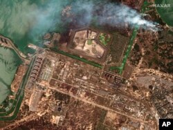 FILE - This satellite image provided by Maxar Technologies shows bush fires outside of the main power plant facilities at the Zaporizhzhia nuclear plant in Russian-occupied Ukraine, Aug. 29, 2022.