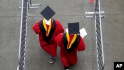 FILE - New graduates walk into the High Point Solutions Stadium before the start of the Rutgers University graduation ceremony, in Piscataway Township, New Jersey, May 13, 2018.