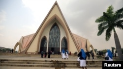 FILE - Catholic nuns are seen heading toward a church in Abuja, Nigeria, March 1, 2020.