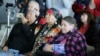 FILE - Sacheen Littlefeather, right, listens to ceremonies marking the 50th anniversary of the Native American occupation of Alcatraz Island Wednesday, Nov. 20, 2019, in San Francisco.