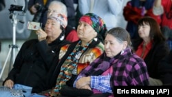 FILE - Sacheen Littlefeather, right, listens to ceremonies marking the 50th anniversary of the Native American occupation of Alcatraz Island Wednesday, Nov. 20, 2019, in San Francisco.