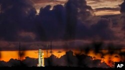 The NASA moon rocket stands ready at sunrise on Pad 39B before the Artemis 1 mission to orbit the moon at the Kennedy Space Center, Monday, Aug. 29, 2022, in Cape Canaveral, Fla. (AP Photo/Brynn Anderson)