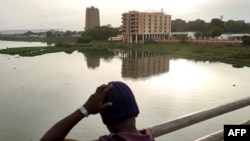 FILE - A boy looks at the city of Bamako from the Martyrs Bridge, on May 25, 2021. 