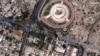 This satellite image provided by Maxar Technologies shows small fires near the tomb of unknown soldier and Iraqi parliament building in Baghdad, taken Aug. 30, after Muqtada al-Sadr called on his supporters to withdraw from the capital's government quarte