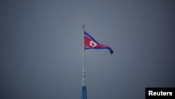 FILE - A North Korean flag flutters in North Korea, in this picture taken inside the demilitarized zone (DMZ) separating the two Koreas, July 19, 2022. 