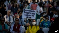 A demonstrator holds a placard during a protest against the suspension of sentences by the government for men convicted of gang raping a Muslim woman, in New Delhi, India, Aug. 27, 2022. 
