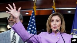 House Speaker Nancy Pelosi of California speaks as Rep. Gregory Meeks, D-N.Y., listens during a news conference on Capitol Hill, Aug. 10, 2022, in Washington. 