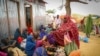 FILE - Somalis who fled drought-stricken areas receive food donations from city residents after arriving at a makeshift camp for the displaced on the outskirts of Mogadishu, Somalia, June 30, 2022. 