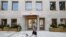 A man walks his dog past Timber House, the city's first mass-timber condo building, in New York City, Aug. 16, 2022.