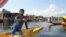 Boatman Imran Dar waits for tourists at the scenic Dal Lake in the summer capital, Srinagar, but says he hardly had any work this year. (A. Pasricha/VOA)