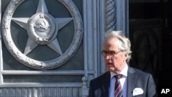 German Ambassador to Russia Rudiger Von Fritsch leaves the Russian foreign ministry building in Moscow, Russia, Friday, March 30, 2018. The Russian Foreign Ministry says it is summoning ambassadors from the countries that expelled Russian diplomats over the poisoning of an ex-spy in Britain, to serve them notices about Moscow's response. (AP Photo/Pavel Golovkin)