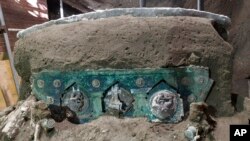 A view of a chariot, with its iron elements, bronze decorations and mineralized wooden remains, that was found in Civita Giuliana, north of Pompeii. Officials at the Pompeii archaeological site near Naples announced the discovery Feb. 27, 2021.