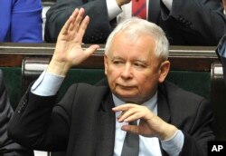 FILE - Leader of the ruling Law and Justice party, Jaroslaw Kaczynski votes to approve a law on court control, in the parliament in Warsaw, Poland, July 20, 2017.