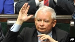 FILE - The leader of the ruling Law and Justice party, Jaroslaw Kaczynski, casts a vote in parliament in Warsaw, Poland, July 20, 2017.