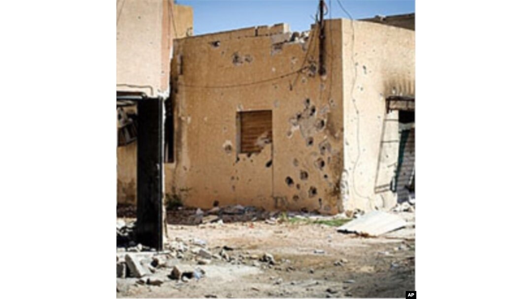 Heavy gunfire pockmarks houses in the Bira neighborhood in Misrata, a rebel bastion 120 kms (75 miles) east of Tripoli, on April 15, 2011