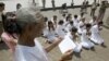 FILE - Rape victims who never received hearings for allegations pray in front of Royal Palace, Phnom Penh, Cambodia.