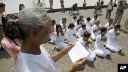 FILE - Rape victims who never received hearings for allegations pray in front of Royal Palace, Phnom Penh, Cambodia.