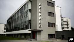 This June 27, 2017 photo shows the Bauhaus main building in Dessau, Germany. The Bauhaus World Heritage is to be extended to include the Houses with Balcony Access on the Dessau-Toerten housing estate and the ADGB Trade Union School.