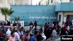 FILE - Palestinian employees of United Nations Relief and Works Agency (UNRWA) take part in a protest against job cuts by UNRWA, in Gaza City Sept. 19, 2018. 