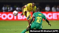 FILE: In a previous matchup, Benin's defender Seidou Baraze (L) is marked by Senegal's forward Sadio Mane during the 2019 Africa Cup of Nations (CAN) quarter final football match between Senegal and Benin at the 30 June stadium in Cairo on July 9, 2019.