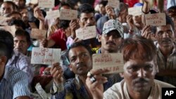 Released Indian fishermen display their name tags at a railway station to leave for their homeland, in Karachi, Pakistan, April 7, 2019. 