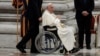 Pope Francis sits in a wheelchair as he leaves after presiding over a vigil, ahead of the Synod of bishops, at Saint Peter's church at the Vatican, Oct. 1, 2024. 