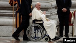 Pope Francis sits in a wheelchair as he leaves after presiding over a vigil, ahead of the Synod of bishops, at Saint Peter's church at the Vatican, Oct. 1, 2024. 