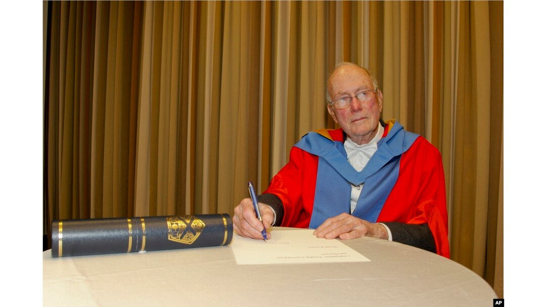 FILE - Charles Townes signs a ceremonial form after receiving an honorary degree from the University of Strathclyde in San Francisco, Jan. 31, 2011.