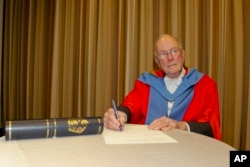 FILE - Charles Townes signs a ceremonial form after receiving an honorary degree from the University of Strathclyde in San Francisco, Jan. 31, 2011.