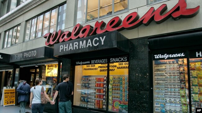 FILE Window shoppers look at a Walgreens storefront in San Francisco, June 26, 2006.