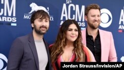 Dave Haywood, from left, Hillary Scott and Charles Kelley, of Lady Antebellum, arrive at the 54th annual Academy of Country Music Awards at the MGM Grand Garden Arena, April 7, 2019, in Las Vegas. 