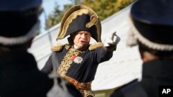 FILE - FILE - In this Sept. 16, 2012 file photo, Oleg Sokolov, wears a 1812-era French army general's uniforms during a battle re-enactment. 