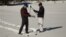 FILE - Frank Gehrke, right, Chief of California Cooperative Snow Surveys Program, measures snowpack in California’s Sierra Nevada Mountains.