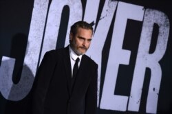 FILE - Cast member Joaquin Phoenix arrives at the Los Angeles premiere of "Joker" at TCL Chinese Theatre, Sept. 28, 2019.