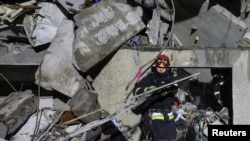 A rescuer works   astatine  a tract  of an flat  gathering  deed  by a Russian aerial  strike, amid Russia's onslaught  connected  Ukraine, successful  Kharkiv, Ukraine October 31, 2024.