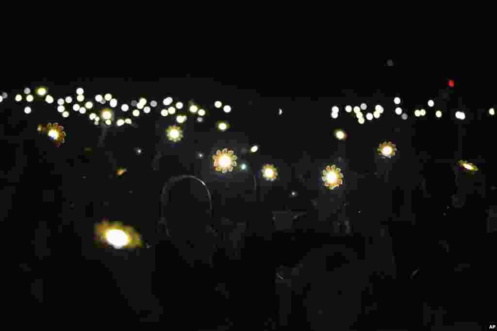 Participants and delegate members hold up solar lanterns in honor of the Paris Agreement, during the opening session of the Climate Conference in Marrakech, Morocco.