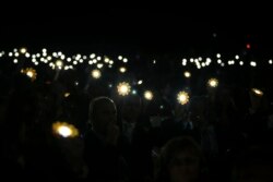 FILE - Participants and delegate members hold up solar lanterns in honor of the Paris Agreement, during the opening session of the Climate Conference in Marrakech, Morocco, Nov. 7, 2016.