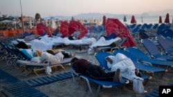 Hundreds of residents and tourists on the eastern Greek island of Kos spent the night sleeping outdoors, July 22, 2017, on beach chairs, in parks and olive groves or in their cars, a night after a powerful earthquake killed two tourists and injured nearly 500 others across the Aegean Sea region, in Greece and Turkey.