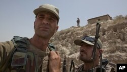 Soldiers hold onto one another while riding in the back of a patrol truck through Dawazai, located in Mohmand Agency along the Pakistan-Afghanistan border, June 1, 2011