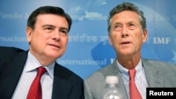 International Monetary Fund officials Jose Vinals (L) and Olivier Blanchard hold a news conference on the release of IMF's World Economic Outlook at the IMF Headquarters in Washington, D.C., July 2009.