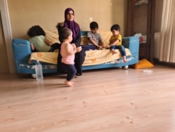 Marwa plays with four of her five children in a home in Istanbul, May 20, 2020. This month's payment was made by a charity, but Marwa doesn't know how next month's payment will be covered. (VOA/Heather Murdock)